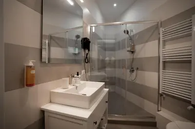 a bathroom with a white sink and a shower at Borghi di Belmonte in Palermo