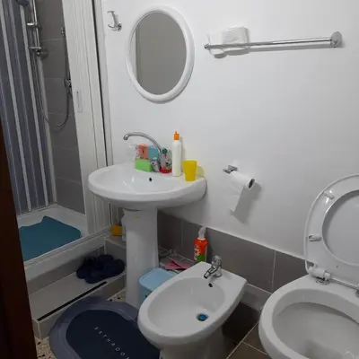 a bathroom with a sink and a toilet and a mirror at Desire'- Le Caprice in Palermo