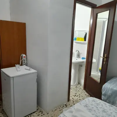 a bathroom with a sink and a small refrigerator at Desire'- Le Caprice in Palermo