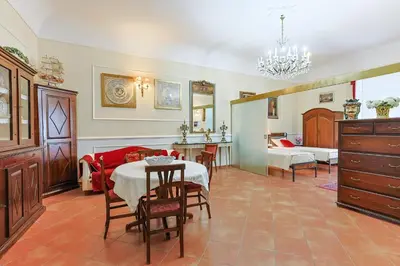 a living room with a table and a dining room at La casa di Dante in Palermo