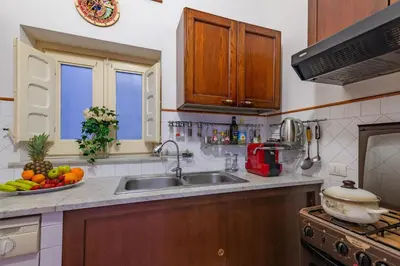 a kitchen with a sink and a bowl of fruit at La casa di Dante in Palermo