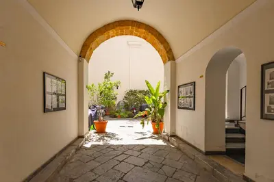 an archway in a building with potted plants at La casa di Dante in Palermo