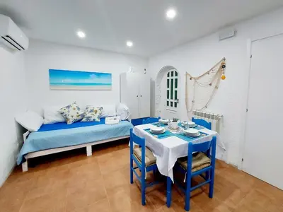 a dining room with a table with blue chairs at Bleu bijou apartment in Palermo