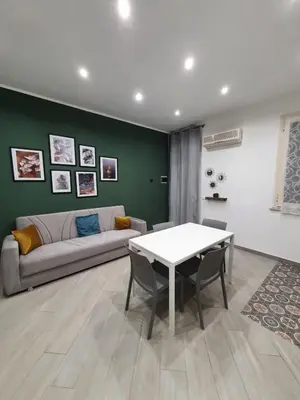 a living room with a couch and a table at Airport Home TUREI & BRINGO Car Rental in Cinisi