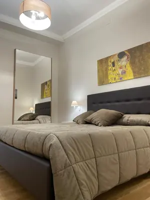 a bedroom with a large bed with a large mirror at Luxury Apartament's Celso- in Palermo