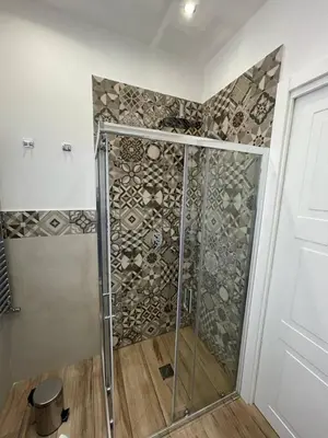 a shower with a glass door in a bathroom at Luxury Apartament's Celso- in Palermo