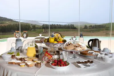 a table topped with a buffet of food and fruit at La Corte del Sole in Calatafimi