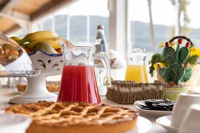 a table with a waffle and a pitcher of red juice at La Corte del Sole in Calatafimi