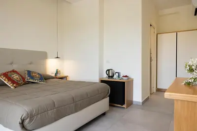 a bedroom with a bed and a table at La Corte del Sole in Calatafimi