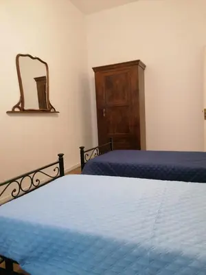 a bedroom with a bed and a dresser and a mirror at La casa nel Borgo in Scopello