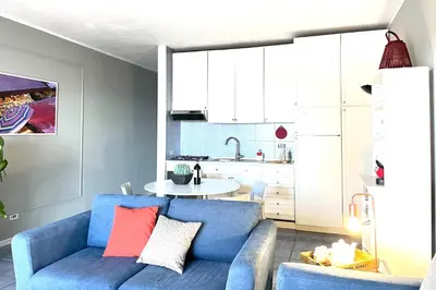 a living room with a blue couch and a table at Vacanze al Mare by DomuSicily in Mondello