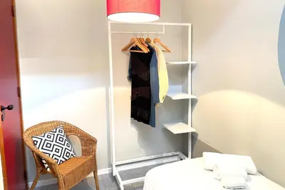 a bedroom with a closet with a bed and a chair at Vacanze al Mare by DomuSicily in Mondello