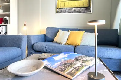 a bedroom with a bed with a television on a dresser at Vacanze al Mare by DomuSicily in Mondello