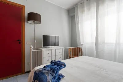 a small bedroom with a bed and a mirror at Vacanze al Mare by DomuSicily in Mondello