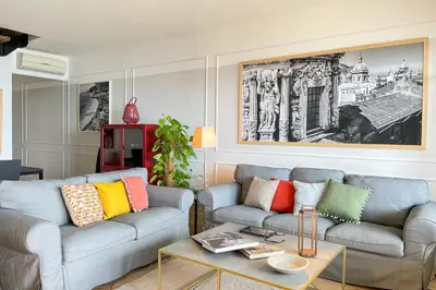 a living room with a couch and a table at Mondello in Terrazza by DomuSicily in Mondello