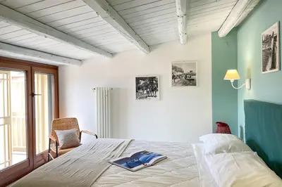 a bedroom with a bed with a book on it at Mondello in Terrazza by DomuSicily in Mondello