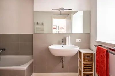 a yellow bathroom with a toilet and a window at Vittorio Emanuele apartment with terrace by Wonderful Italy in Palermo