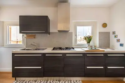 a kitchen with a sink and a stove at Vittorio Emanuele apartment with terrace by Wonderful Italy in Palermo