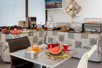 a table with fruit on it in a kitchen at B&B A casa di Aurora rooms in San Vito lo Capo