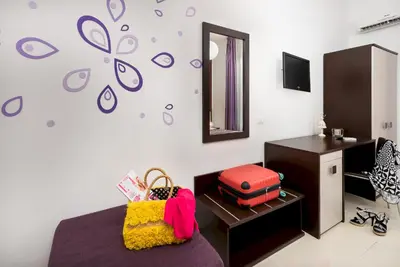 a bedroom with a bed and a dresser and a mirror at B&B A casa di Aurora rooms in San Vito lo Capo