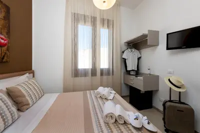 a hotel room with a bed with towels on it at B&B A casa di Aurora rooms in San Vito lo Capo