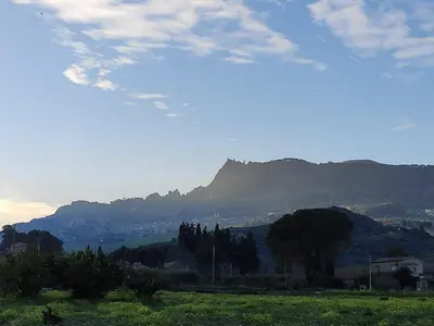 a field with a mountain in the background at Casa Paradiso in Castronuovo di Sicilia