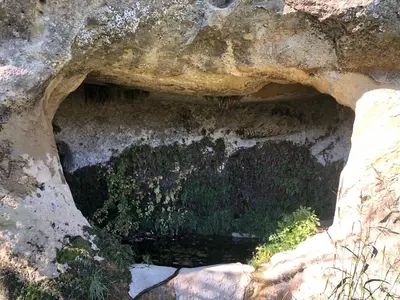 a cave in a rock with water in it at Casa Paradiso in Castronuovo di Sicilia