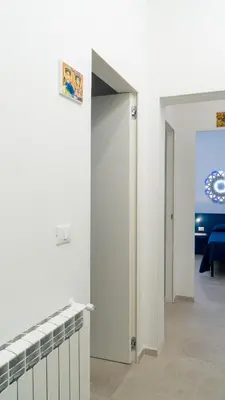 a room with white walls and an open door at Casa Paradiso in Castronuovo di Sicilia