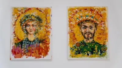 two paintings of a man and a woman at Casa Paradiso in Castronuovo di Sicilia