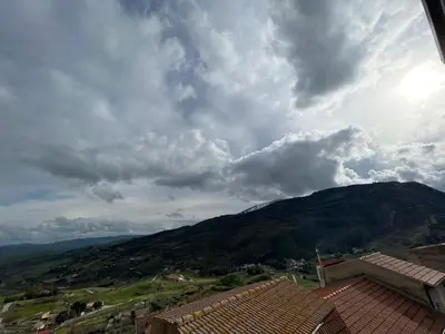 a view of a mountain under a cloudy sky at Casa Paradiso in Castronuovo di Sicilia