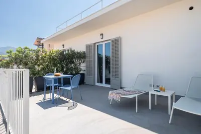 a patio with chairs and a table on a balcony at Attico 37 - Comfort room con terrazza privata in Palermo