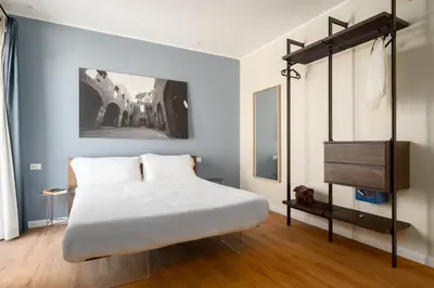a bedroom with a large white bed and a tv at Attico 37 - Comfort room con terrazza privata in Palermo