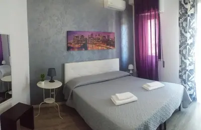 a bedroom with two beds with towels on them at Bed & Breakfast Amari 58 in Palermo