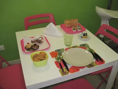a white table with a plate of food on it at Bed & Breakfast Amari 58 in Palermo