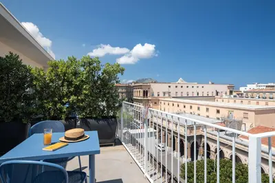 a table on a balcony with a view of the city at Attico 37 - Comfort room con terrazza privata in Palermo