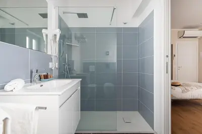 a bathroom with a white sink and a shower at Attico 37 - Comfort room con terrazza privata in Palermo