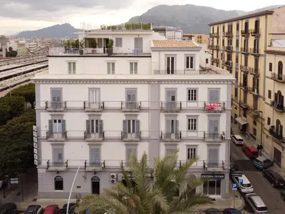 a white building with balconies and a street at Attico 37 - Comfort room con terrazza privata in Palermo