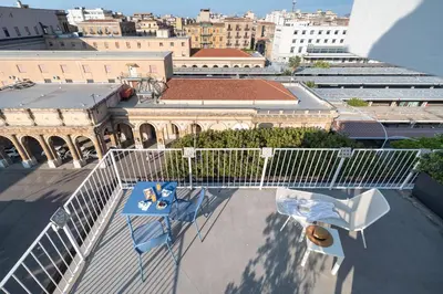 a view of a balcony with a table and a chair at Attico 37 - Comfort room con terrazza privata in Palermo