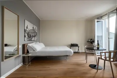 a bedroom with a bed and a table and a mirror at Attico 37 - Queen room con terrazza privata in Palermo