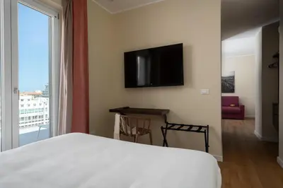 a bedroom with a bed and a flat screen tv at Attico 37 - Queen room con terrazza privata in Palermo