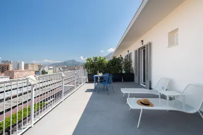 a balcony with chairs and a table on a building at Attico 37 - Queen room con terrazza privata in Palermo