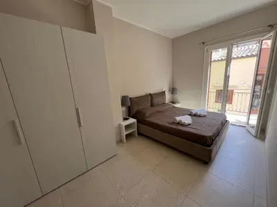 a bedroom with a bed and a large window at Luce del golfo in Castellammare del Golfo