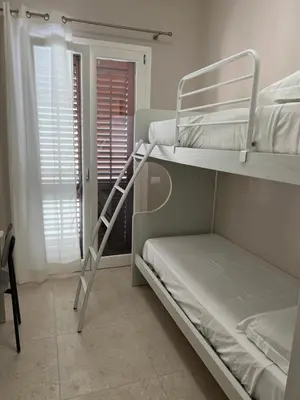 a bedroom with two bunk beds and a window at Luce del golfo in Castellammare del Golfo
