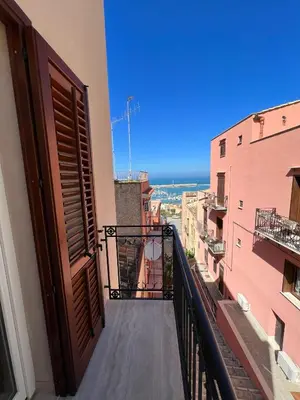 a balcony of a building with a view of the ocean at Luce del golfo in Castellammare del Golfo