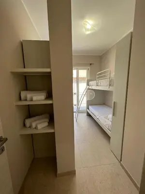 a small room with bunk beds and a hallway at Luce del golfo in Castellammare del Golfo
