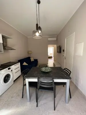 a kitchen and living room with a table and chairs at Luce del golfo in Castellammare del Golfo