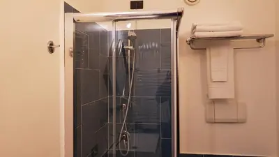 a shower with a glass door in a bathroom at Addaura Village e Congressi in Mondello