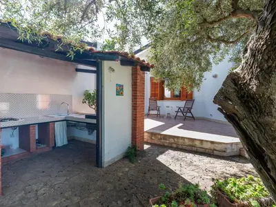 a house with a kitchen and a patio at Villa New Charme in Castellammare del Golfo