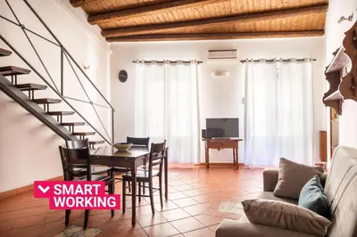 a living room with a table and a couch at Casa Meli dietro Piazza San Domenico by Wonderful Italy in Palermo