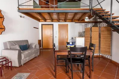 a living room with a table and a couch at Casa Meli dietro Piazza San Domenico by Wonderful Italy in Palermo